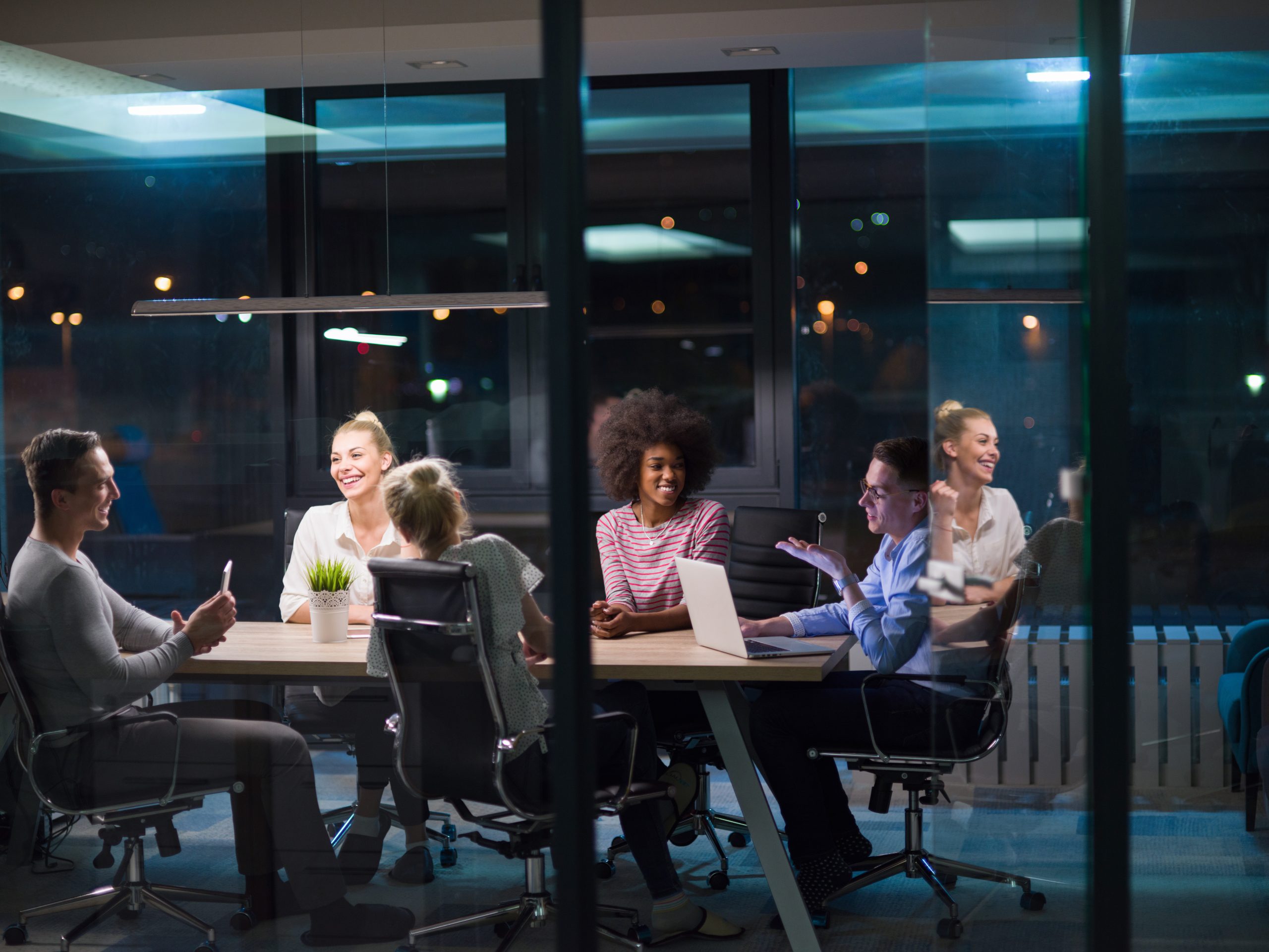 Multiethnic startup business team in night office